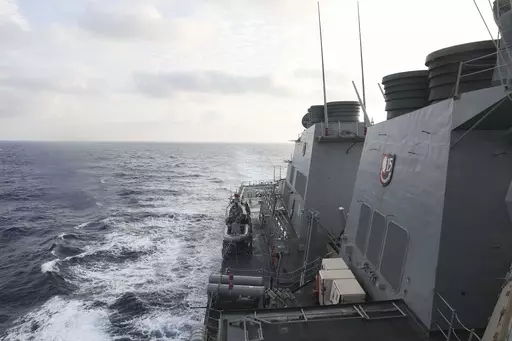 In this photo provided by the U.S. Navy, the Arleigh Burke-class guided-missile destroyer USS Milius (DDG 69) conducts routine underway operations in South China Sea, Friday March 24, 2023. China threatened “serious consequences” Friday, after the U.S. Navy sailed a destroyer around the disputed Paracel Islands in the South China Sea the second day in a row, which Beijing claimed was a violation of its sovereignty and security.(Mass Communication Specialist 1st Class Greg Johnson/U.S. Navy v