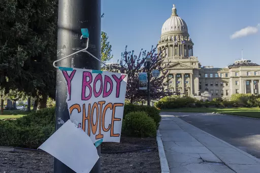 A sign reading "My body, my choice," is taped to a hanger taped to a streetlight in front of the Idaho state Capitol Building in Boise, Idaho, May 3, 2022. Abortion is banned in Idaho at all stages of pregnancy, but the governor on Wednesday, April 5, 2023 signed another law making it illegal to provide help within the state’s boundaries to minors seeking abortion without parental consent. (Sarah A. Miller/Idaho Statesman via AP, File)