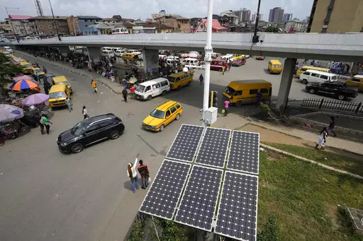 Solar panels sit near a street in the Obalende neighborhood of Lagos, Nigeria, Saturday, Aug. 20, 2022. Access to more and cleaner energy while continuing to grow economically will be a top priority for African nations in the upcoming United Nations climate conference in November, top officials and climate experts on the continent said. (AP Photo/Sunday Alamba)