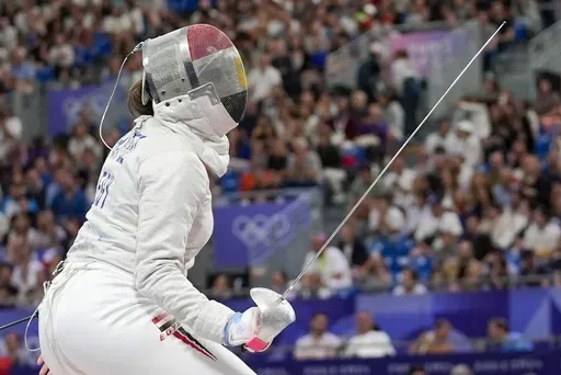 Egypt's Nada Hafez competes with United States' Elizabeth Tartakovsky in the women's individual Sabre round of 32 competition during the 2024 Summer Olympics at the Grand Palais, Monday, July 29, 2024, in Paris, France. (AP Photo/Andrew Medichini)