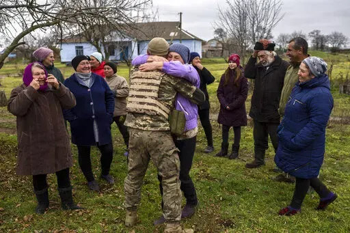 In the village of Vavylove, a Ukrainian serviceman embraces his mother for the first time since Russian troops withdraw from the Kherson region, southern Ukraine, Sunday, Nov. 13, 2022. Families were torn apart when Russia invaded in February, as some fled and others hunkered down. Now many are seeing one another for the first time in months, after Moscow's latest retreat amid a Ukrainian counteroffensive that has retaken a pocket of territory wedged between the regional capitals of Kherson and 
