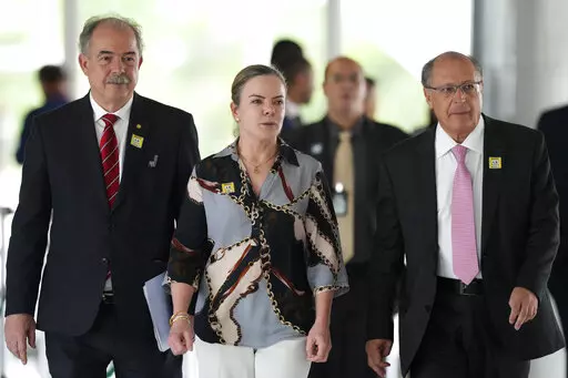 Economist Aloizio Mercadante, from left, Workers' Party President Gleisi Hoffmann and Brazil's Vice President-elect Geraldo Alckmin, arrive for a press conference after meeting with Ciro Nogueira, outgoing President Jair Bolsonaro's chief of staff, at the Planalto Presidential Palace, in Brasilia, Brazil, Thursday, Nov. 3, 2022. President-elect Luiz Inacio Lula da Silva’s team arrived in Brazil’s capital Thursday to begin the process of transferring power. (AP Photo/Eraldo Peres)