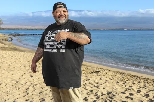 Joshua Kamalo, 43, is seen on the beach at Haycraft Park, Wednesday, Dec. 18, 2024, in Maalaea, Hawaii. (AP Photo/Marco Garcia)