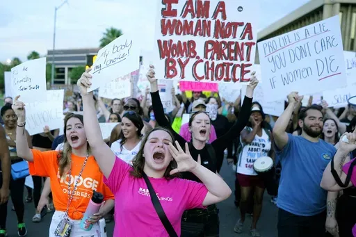Protesters join thousands marching around the Arizona Capitol in Phoenix, protesting the U.S. Supreme Court's decision to overturn Roe v. Wade, June 24, 2022. (AP Photo/Ross D. Franklin, File)