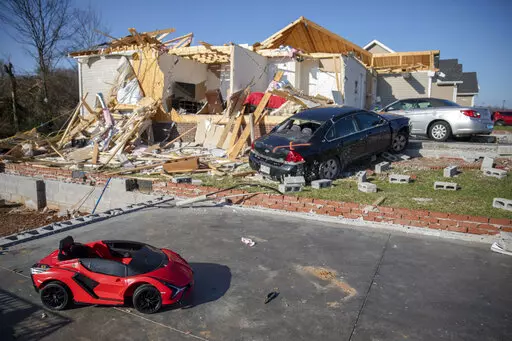 A child's toy car sits near damaged cars and homes Tuesday, Dec. 14, 2021, in Bowling Green, Ky., after a tornado touched down in the middle of the night. According to three different reports released Monday, Jan. 10, 2021, the United States staggered through a steady onslaught of deadly billion-dollar climate disasters in an extra hot 2021, while the nation’s greenhouse gas emissions last year jumped 6% because of surges in coal and long-haul trucking, putting America further behind its 2030 