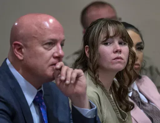 Hannah Gutierrez-Reed, center, sits with her attorney Jason Bowles and paralegal Carmella Sisneros during her sentencing hearing in Santa Fe, New Mexico, on Monday, April 15, 2024. Gutierrez-Reed, the armorer on the set of the Western film "Rust," was sentenced to 18 months in prison for involuntary manslaughter in the death of cinematographer Halyna Hutchins, who was fatally shot by Alec Baldwin in 2021. (Eddie Moore/The Albuquerque Journal via AP, Pool)