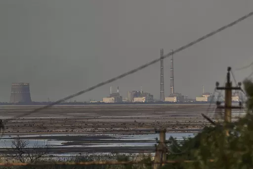 The Zaporizhzhia nuclear power plant, Europe's largest, is seen in the background of the shallow Kakhovka Reservoir after the dam collapse, in Energodar, Russian-occupied Ukraine, Tuesday, June 27, 2023. The U.N. atomic watchdog said in a statement late Monday, July 24, 2023, its staff at Ukraine’s Russian-occupied Zaporizhzhia Nuclear Power Plant report seeing anti-personnel mines around the site. The report comes as Kyiv pursues a counteroffensive against the Kremlin’s entrenched forces af