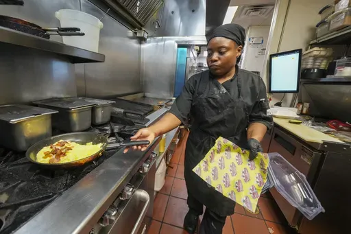 Johkiya Pierre prepares a fresh omelette at The Breakfast Brothers restaurant, Wednesday, Feb. 12, 2025, in Arlington, Texas. (AP Photo/Julio Cortez)