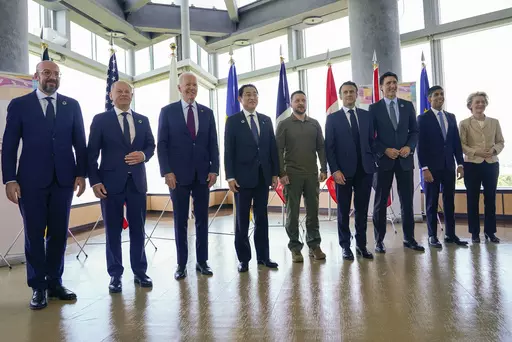 President Joe Biden, third from left, and Ukrainian President Volodymyr Zelenskyy, center, and other G7 leaders pose for a photo before a working session on Ukraine during the G7 Summit in Hiroshima, Japan, Sunday, May 21, 2023. Other leaders from right to left, European Commission President Ursula von der Leyen, Britain's Prime Minister Rishi Sunak, Canada's Prime Minister Justin Trudeau, France's President Emmanuel Macron, Zelenskyy, Japan's Prime Minister Fumio Kishida, Biden, German Chancell