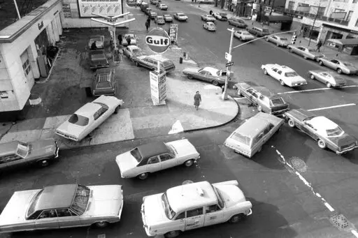 Cars line up in two directions at a gas station in New York City, on Dec. 23, 1973. An unhappy confluence of events has economists reaching back to the days of disco and the bleak high-inflation, high-unemployment economy of nearly a half century ago. No one thinks stagflation is in sight. But as a longer-term threat, it can no longer be dismissed. (AP Photo/Marty Lederhandler, File)