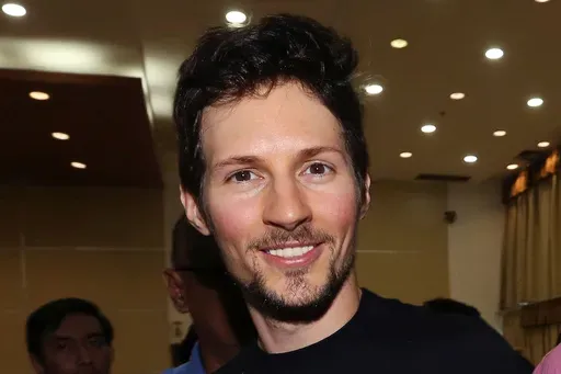 Telegram co-founder Pavel Durov, center, smiles following his meeting with Indonesian Communication and Information Minister Rudiantara in Jakarta, Indonesia on Aug. 1, 2017. (AP Photo/Tatan Syuflana, File)