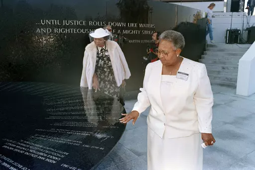 Mamie Till-Mobley, mother of lynching victim Emmett Till, right, and Wilma Allen, of New Orleans, search for their relatives' names on the black granite table at the Civil Rights Memorial in Montgomery, Ala., Nov. 5, 1989. A memorial honoring Till-Mobley will be unveiled Saturday, April 29, 2023, outside the suburban Chicago high school she attended as a young woman, long before she became a critical player in the Civil Rights Movement. (AP Photo/Dave Martin, File)