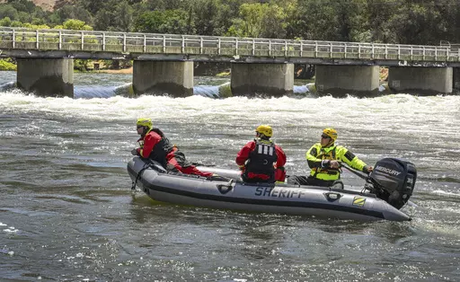 Fresno County Sheriff's Office search and rescue team members return upriver to a boat launch near the Pine Flat Dam near Sanger, Calif., after reports that a boy's body had been recovered on the Kings River, May 22, 2023. California rivers fed by winter's massive Sierra Nevada snowpack have been turned into deadly torrents, drawing warnings from public safety officials ahead of the Memorial Day weekend and the traditional start of outdoor summer recreation. (Craig Kohlruss/The Fresno Bee via AP