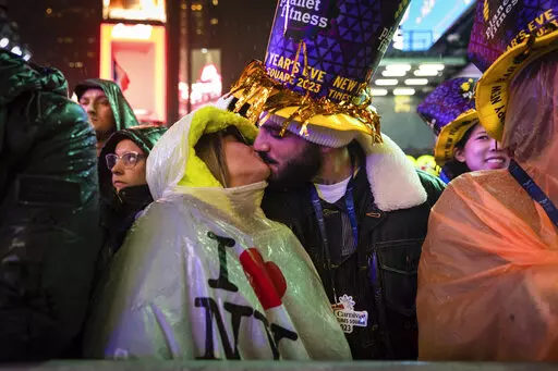 A couple kisses in Times Square as they attend the New Year's Eve celebrations on Saturday, Dec. 31, 2022, in New York. (AP Photo/Stefan Jeremiah)