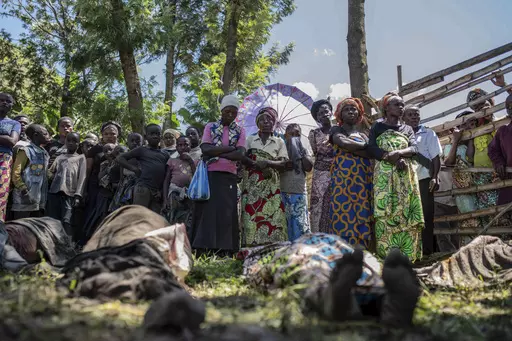 Relatives gather to identify bodies in the village of Nyamukubi, South Kivu province, Congo, Saturday, May 6, 2023. The death toll from flash floods and landslides in eastern Congo has risen to over 150, with some 100 people still missing, according to a provisional assessment given by the governor and authorities in the country's South Kivu province. (AP Photo/Moses Sawasawa)