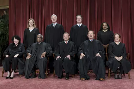 Members of the Supreme Court sit for a new group portrait following the addition of Associate Justice Ketanji Brown Jackson, at the Supreme Court building in Washington, Oct. 7, 2022. Bottom row, from left, Justice Sonia Sotomayor, Justice Clarence Thomas, Chief Justice John Roberts, Justice Samuel Alito, and Justice Elena Kagan. Top row, from left, Justice Amy Coney Barrett, Justice Neil Gorsuch, Justice Brett Kavanaugh, and Justice Ketanji Brown Jackson. The Supreme Court is adopting its first