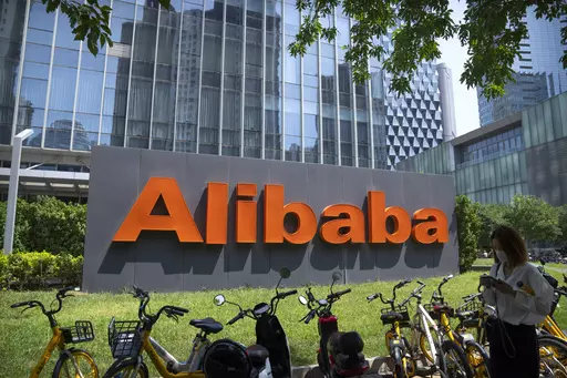 The logo of Chinese technology firm Alibaba is seen at its office in Beijing on Aug. 10, 2021. Alibaba Group Holding on Thursday, May 18, 2023 said that it plans to spin-off of its cloud computing unit and that its logistics and grocery units would begin exploring initial public offerings, as the e-commerce firm kickstarts a restructuring process of its businesses aimed at spurring growth. (AP Photo/Mark Schiefelbein, File)