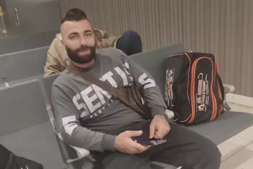 In this photo from May 2023 by a relative, Ali Sheikhi, 29, poses for a photograph at an airport in an undisclosed location. Sheikhi was trying to reach Europe from Libya on an overcrowded fishing vessel that capsized in the Mediterranean in the early hours of June 14, 2023, killing dozens of people, 104 passengers are rescued, and hundreds are feared to be missing. Sheikhi's relatives in Germany and Syria told The Associated Press they had recognized Ali Sheikhi among the survivors taken to a s