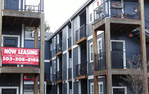 A 'Now Leasing' sign hangs off an apartment building staircase in southeast Portland, Ore., on Wednesday, Dec. 9, 2021. Rents are starting to come down after spiking to record levels this past summer, but experts are uncertain if the slowdown will continue.  The national median asking rent was up 14% in July 2022 over July the previous year. That's the smallest annual increase since November 2021. Experts say the market could slow further toward the end of the year, but there’s still a lot of 