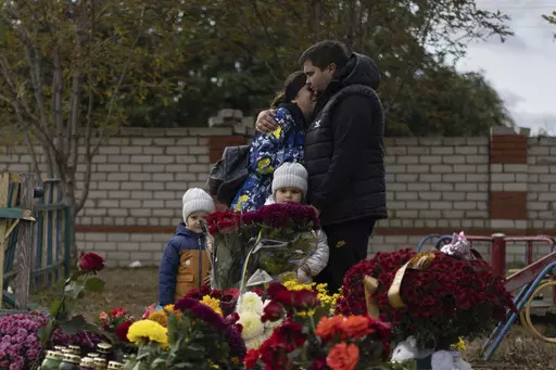 People react near the memorial for the victims of a Russian rocket attack in the village of Hroza near Kharkiv, Ukraine, Sunday, Oct. 8, 2023. A report by U.N investigators has pointed a finger at Russia as likely being responsible for the deaths of 59 civilians at a village café hit by a missile in eastern Ukraine in early October, in what was one of the deadliest strikes since the Kremlin’s forces launched a full-scale invasion 20 months ago. (AP Photo/Alex Babenko, File)