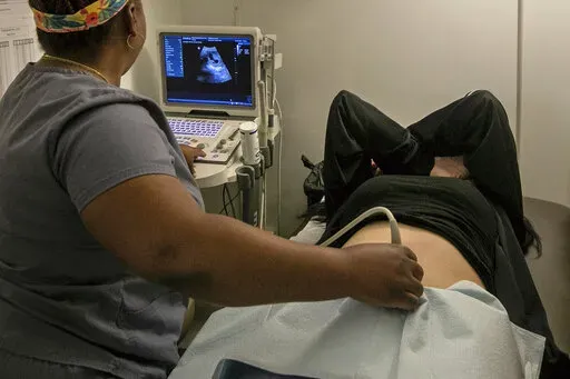An operating room technician performs an ultrasound on a patient at an abortion clinic in Shreveport, La., Wednesday, July 6, 2022. The abortion bans taking effect after the nation's highest court overturned Roe v. Wade in June 2022 vary greatly in how they define when a pregnancy can be ended. (AP Photo/Ted Jackson)
