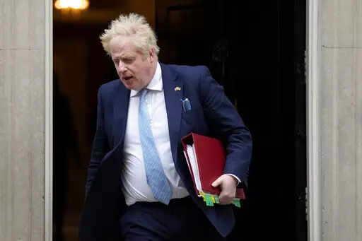Britain's Prime Minister Boris Johnson leaves 10 Downing Street to attend the weekly Prime Ministers' Questions session in parliament in London, on March 30, 2022. U.K. Prime Minister Boris Johnson’s office says he will be issued a fine for breaching COVID-19 regulations following allegations of lockdown parties at government offices. Treasury Chief Rishi Sunak will also be fined. (AP Photo/Frank Augstein)