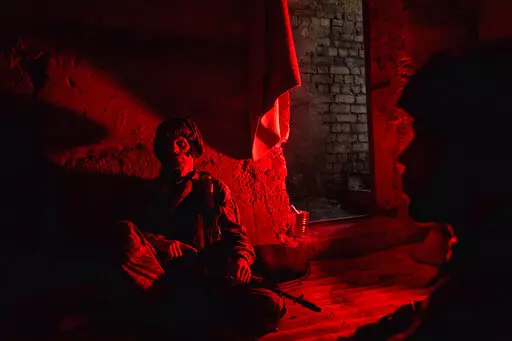 Ukrainian servicemen of Khartia battalion take cover in a shelter at the frontline near Kharkiv, Ukraine, on Tuesday, July 12, 2022. (AP Photo/Evgeniy Maloletka)