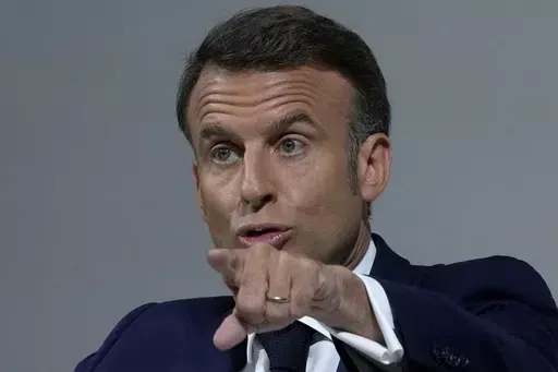 French President Emmanuel Macron delivers a speech, Wednesday, June 12, 2024 in Paris. President Emmanuel Macron is addressing French voters on Wednesday for the first times since he has called snap national election following a crushing defeat of his party by the far-right in the European vote. (AP Photo/Michel Euler)
