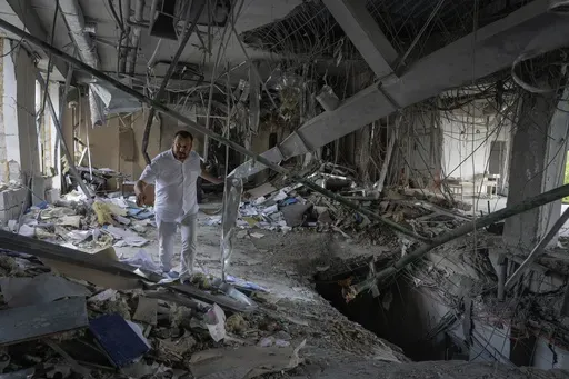 Alya Gali, a Gaza Strip-born doctor, looks at debris two weeks after a missile killed nine as it hit a private clinic where he has worked for most of his professional life in Kyiv, Ukraine, Monday, July 22, 2024. Russia’s full-scale invasion of Ukraine in 2022 catapulted Gali’s life into the chaos of constant air raids and missile attacks. Israel’s war on Hamas turned his hometown into a hellscape, uprooting his family and killing two of his relatives. (AP Photo/Efrem Lukatsky)