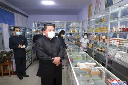 In this photo provided by the North Korean government, North Korean leader Kim Jong Un, center, visits a pharmacy in Pyongyang, North Korea Sunday, May 15, 2022. Independent journalists were not given access to cover the event depicted in this image distributed by the North Korean government. The content of this image is as provided and cannot be independently verified.   Korean language watermark on image as provided by source reads: "KCNA" which is the abbreviation for Korean Central News Agen