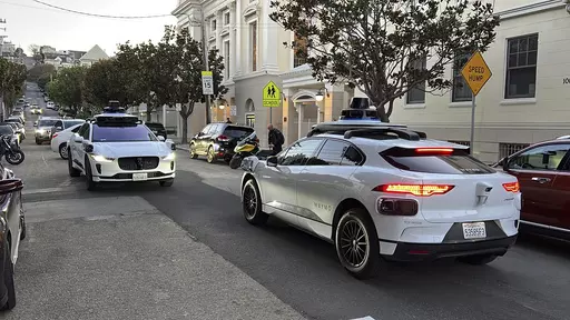 Two Waymo driverless taxis stop and face each other on a street in San Francisco before driving past each other, on Feb. 15, 2023. Cruise, a subsidiary of General Motors, and Waymo, a spinoff from Google, both are on the verge of operating 24-hour services that would transport passengers throughout one of the most densely populated U.S. cities in vehicles that will have no one sitting in the driver’s seat. (AP Photo/Terry Chea)