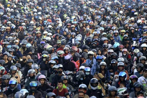 Motorists queue up to board a ferry to cross to Sumatra Island ahead of Eid al-Fitr holiday at Ciwandan Port in Cilegon, Indonesia, Sunday, April 7, 2024. Millions of Indonesians are packing bus and train stations, airports and highways as they head to hometowns to celebrate Thursday's Eid al-Fitr festival with family. (AP Photo/Dziki Oktomauliyadi)