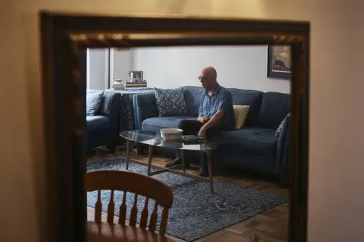 Ron Spitzer, stroke survivor, rests at home on Monday, July 15, 2024, in New York. In the 1980s and ’90s, h played bass and drums in rock bands, but a stroke in 2009 put Spitzer in a wheelchair, his voice a whisper. (AP Photo/Andres Kudacki)