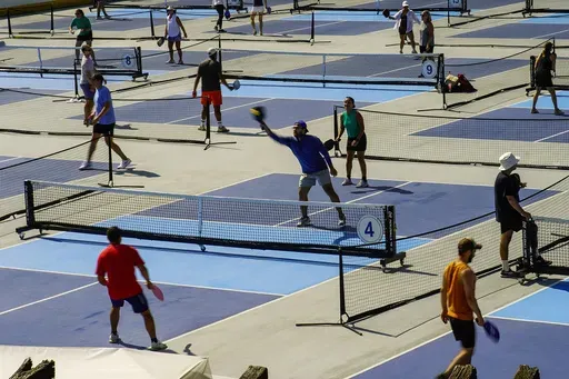 People practice pickleball on the courts of CityPickle at Central Park's Wollman Rink, Saturday, Aug. 24, 2024, in New York. (AP Photo/Eduardo Munoz Alvarez)