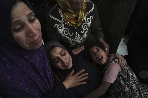 Palestinians grieve over the bodies of their relatives, who were killed in an Israeli airstrike, as they prepare for burial at a hospital in Beit Lahiya, Gaza Strip, on Wednesday, April 2, 2025. (AP Photo/Jehad Alshrafi)