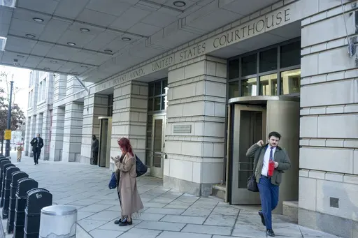 Pedestrians walk past the E. Barrett Prettyman Federal Courthouse, Monday, Feb. 24, 2025. (AP Photo/Kevin Wolf)