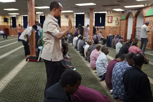 Yusuf Abdulle, standing, director of the Islamic Association of North America, prays with fellow Muslims at the Abubakar As-Saddique Islamic Center in Minneapolis on Thursday, May 12, 2022. Minneapolis will allow broadcasts of the Muslim call to prayer at all hours, Thursday, April 14, 2023, becoming the first major U.S. city to allow the announcement or “adhan” to be heard over speakers five times a day, year-round. (AP Photo/Jessie Wardarski)