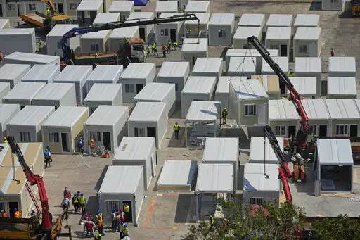 An aerial view shows a construction site of a new makeshift COVID-19 hospital and isolation facilities, in Tsing Yi of Hong Kong, Saturday, Feb. 26, 2022. For two years, Hong Kong successfully insulated most of its residents from COVID-19 and often went months without a single locally spread case. Then the omicron variant showed up. The fast-spreading mutation breached Hong Kong’s defenses and has been spreading rapidly through one of the world’s most densely populated places. (AP Photo/Kin 