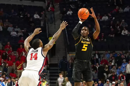 Missouri guard D'Moi Hodge (5) shoots a 3-pointer over Mississippi guard Tye Fagan (14) during the first half of an NCAA college basketball game in Oxford, Miss., Tuesday, Jan. 24, 2023. (AP Photo/Rogelio V. Solis)