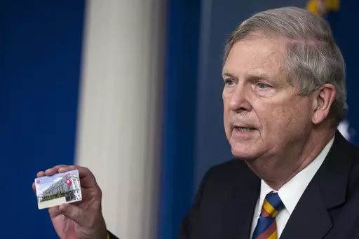 Agriculture Secretary Tom Vilsack holds up a Supplemental Nutrition Assistance Program Electronic Benefits Transfer (SNAP EBT) card during a news conference at the White House, Wednesday, May 5, 2021, in Washington. Nearly 21 million children in the U.S. and its territories are expected to receive food benefits this summer through a newly permanent federal program, the United States Department of Agriculture announced Wednesday, Jan. 10, 2024. “No child in this country should go hungry,” Vil