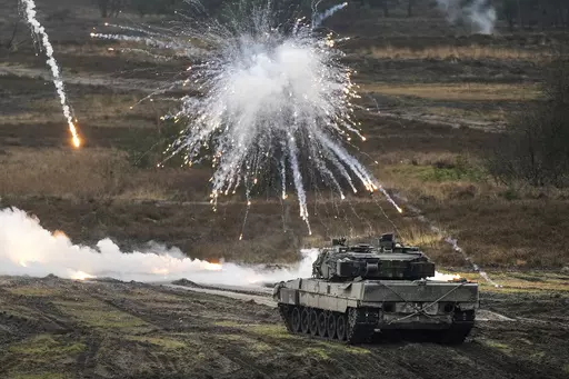 A Leopard 2 tank is seen in action at the Bundeswehr tank battalion 203 at the Field Marshal Rommel Barracks in Augustdorf, Germany, Wednesday, Feb. 1, 2023. Germany’s defense industry says it stands ready to supply Ukraine with much-needed arms and ammunition, but needs clarity about what the country requires before investing in further production capacity. (AP Photo/Martin Meissner, File )