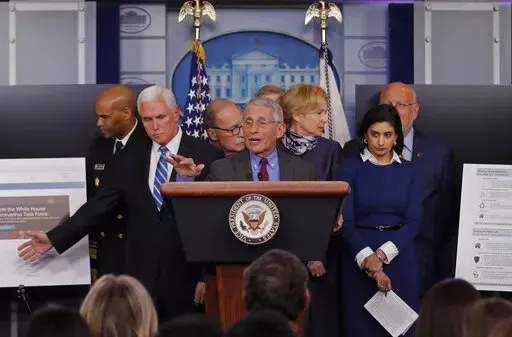 Dr. Anthony Fauci, director of the National Institute of Allergy and Infectious Diseases speaks in the briefing room of the White House in Washington, Tuesday, March, 10, 2020, about the coronavirus outbreak as Vice President Mike Pence, second from left gestures to a display. Also onstage from left are U.S. Surgeon General Jerome Adams, Pence, White House chief economic adviser Larry Kudlow, Fauci, Dr. Deborah Birx, White House coronavirus response coordinator, Administrator of the Centers for 