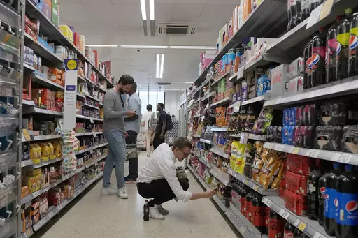 Shoppers buy food in a supermarket in London, on Aug. 17, 2022. Food prices and overall inflation will rise as temperatures climb with climate change, a new study by an environmental scientist and the European Central Bank found. (AP Photo/Frank Augstein, File)