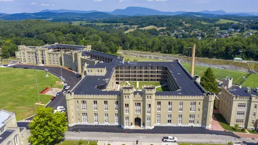 This July 15, 2020, file photo shows the barracks at Virginia Military Institute in Lexington, Va. The Virginia Military Institute will change its student-run honor court to make it more fair to cadets as part of a response to a state-ordered investigation into racism and sexism. The Washington Post reports VMI detailed the reforms in a progress report Friday, Feb. 4, 2022. (AP Photo/Steve Helber, File)