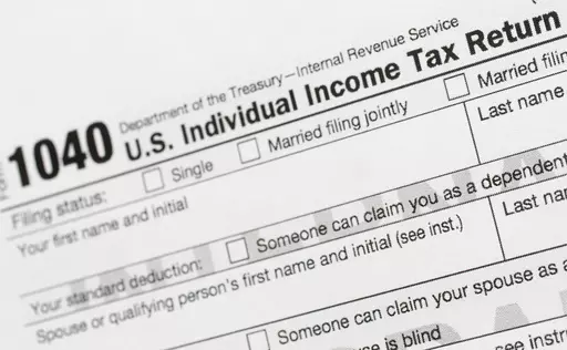 A portion of the 1040 U.S. Individual Income Tax Return form is shown July 24, 2018, in New York. The IRS has been tasked with looking into how to create a government-operated electronic free-file tax return system for all. Congress has directed the IRS to report in on how such a system might work. (AP Photo/Mark Lennihan, File)