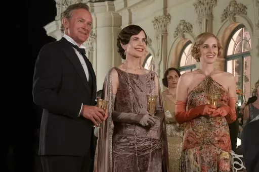 This image released by Focus Features shows Hugh Bonneville, from left, Elizabeth McGovern and Laura Carmichael in a scene from "Downton Abbey: A New Era." (Ben Blackall/Focus Features via AP)