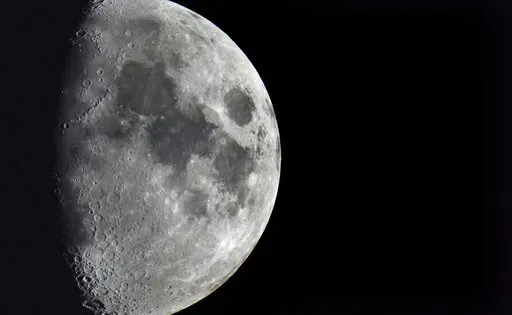 Impact craters cover the surface of the moon, seen from Berlin, Germany, Tuesday, Jan. 11, 2022. The moon is about to get walloped by 3 tons of space junk, a punch that will carve out a crater that could fit several semitractor-trailers. A leftover rocket is expected to smash into the far side of the moon at 5,800 mph (9,300 kph) on Friday, March 4, 2022, away from telescopes’ prying eyes. It may take weeks, even months, to confirm the impact through satellite images. (AP Photo/Michael Sohn, F