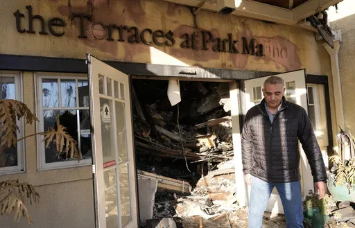 Diversified Healthcare Services President/CEO Adam Khalifa reacts after seeing the damage from the Eaton Fire to The Terraces at Park Marino assisted living facility on Monday, Jan. 13, 2025, in Pasadena, Calif. (AP Photo/Chris Pizzello)