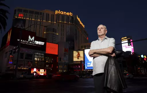 Jeff German, host of "Mobbed Up," poses with Planet Hollywood, formerly the Aladdin, in the background on the Strip in Las Vegas, Wednesday, June 2, 2021. Authorities say German, a Las Vegas investigative reporter has been stabbed to death outside his home and police are searching for a suspect. The Las Vegas Review-Journal says officers found journalist German dead with stab wounds around 10:30 a.m. Saturday, Sept. 3, 2022, after authorities received a 911 call. (K.M. Cannon/Las Vegas Review-Jo