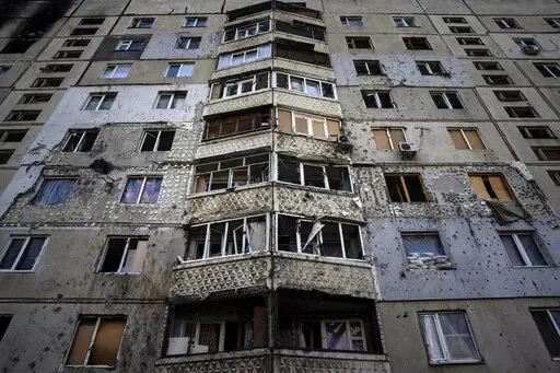 An apartment building damaged by a Russian attack in Saltivka district in Kharkiv, Ukraine, July 5, 2022. As Russia's invasion of Ukraine grinds into its fifth month, some residents close to the front lines remain in shattered and nearly abandoned neighborhoods. One such place is Kharkiv's neighborhood of Saltivka, once home to about half a million people. Only perhaps dozens live there now, in apartment blocks with no running water and little electricity. (AP Photo/Evgeniy Maloletka, File)